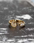 Elegant crescent moon ring in yellow gold with pave-set diamonds, showcased on a dark backdrop. Custom jewelry by Bena Jewelry.