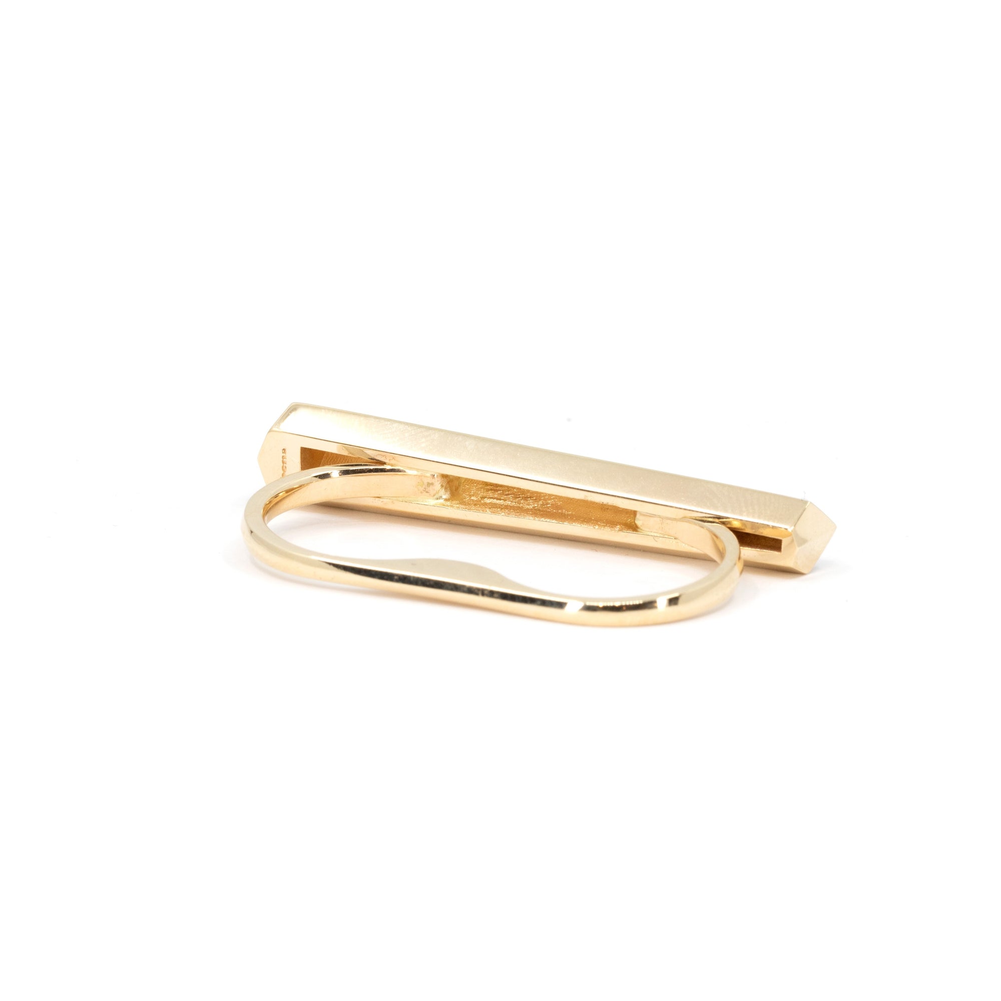 Back view of a designer ring featuring the independent brand's logo engraved in the gold: BENA. This is a modern ring in 14-carat yellow gold. Here we see the double ring, as this jewel is designed to be worn on two fingers. It's a comfortable, luxurious piece of jewelry that reflects light in all directions. Created in Montreal, Canada, available at Ruby Mardi fine jewelry.