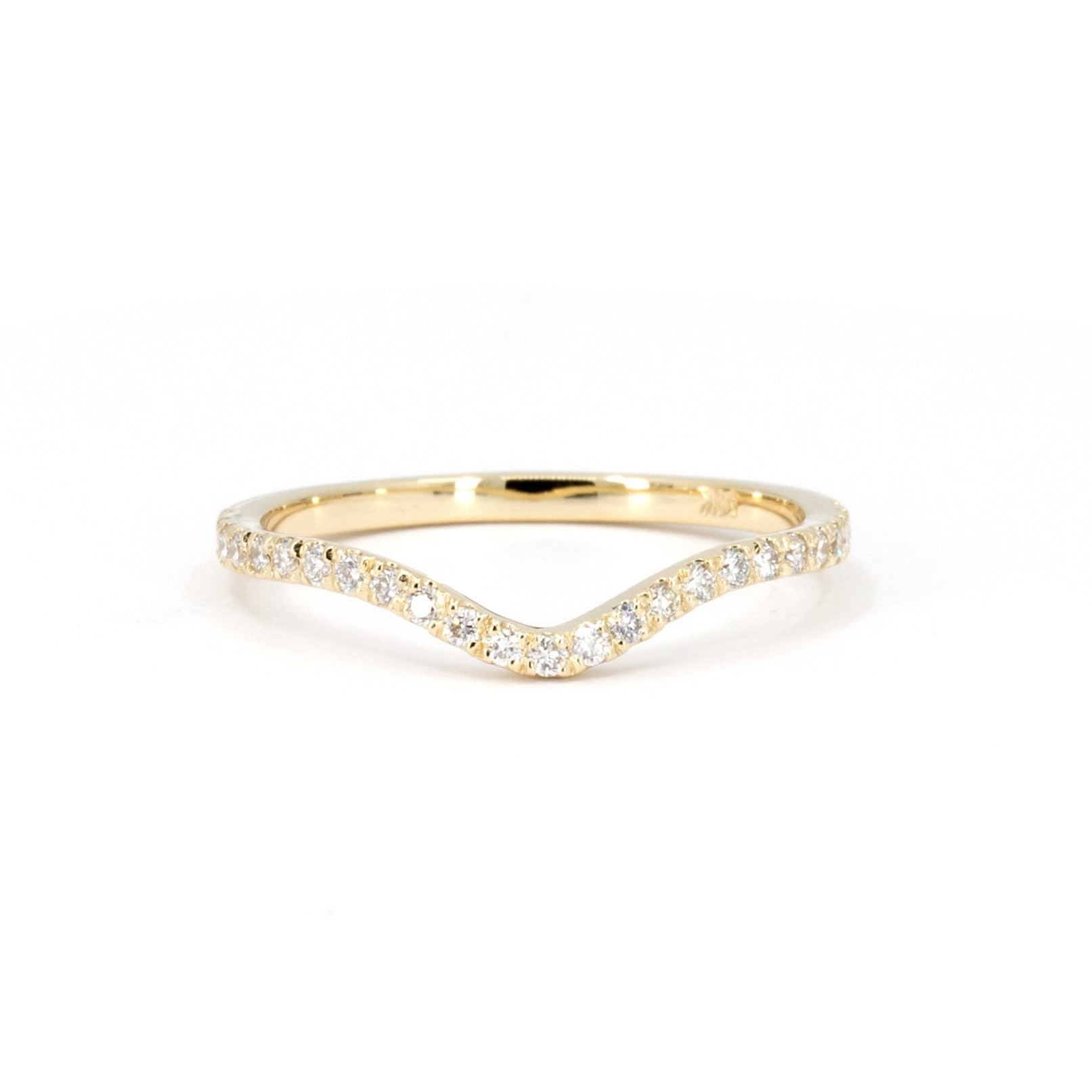 Yellow gold wedding band with a subtle curve and diamonds, custom-designed to match an engagement ring. Crafted by Bena Jewelry in Montreal, Canada.