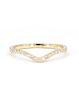 Yellow gold wedding band with a subtle curve and diamonds, custom-designed to match an engagement ring. Crafted by Bena Jewelry in Montreal, Canada.