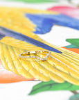 Custom bridal wedding band in yellow gold with a curved design and diamonds, displayed on a soft-colored backdrop. Made by Bena Jewelry, Montreal, Canada.