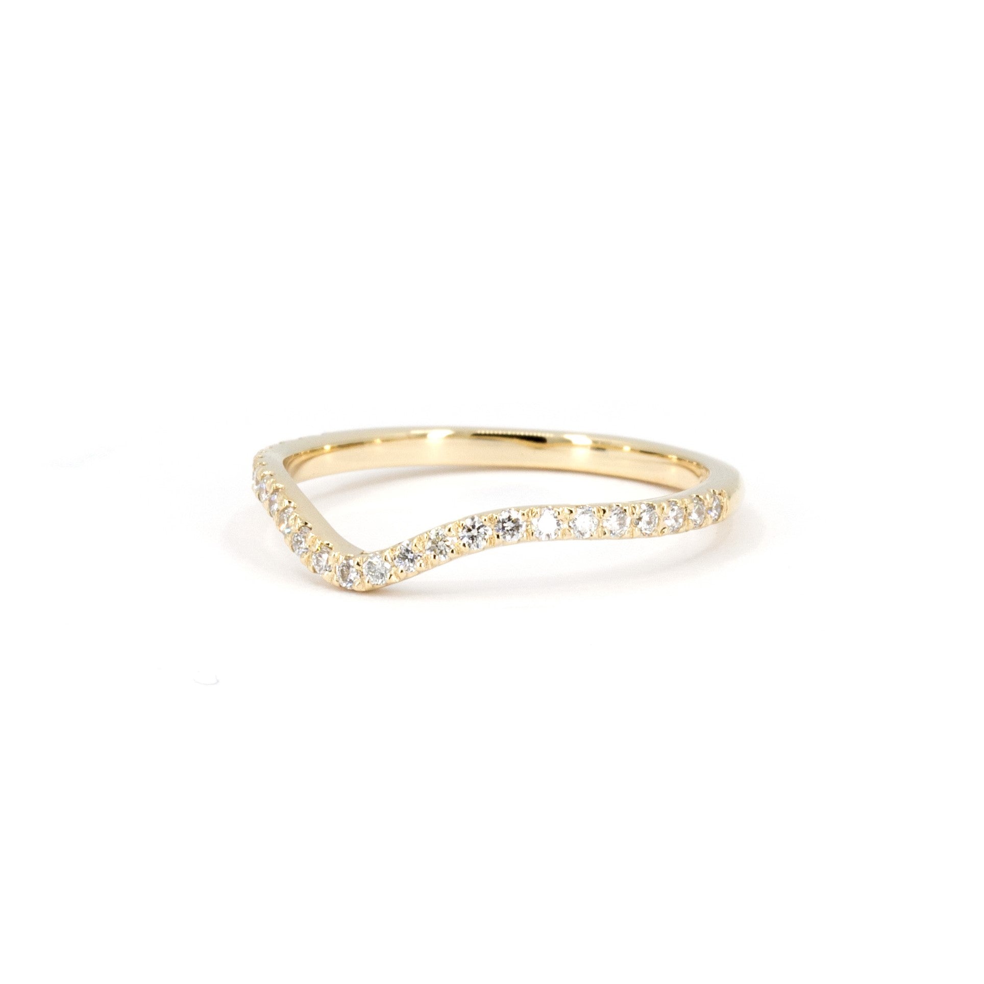 Classic yellow gold curved wedding band featuring diamonds, made to complement an engagement ring. Custom-made by Bena Jewelry in Montreal.