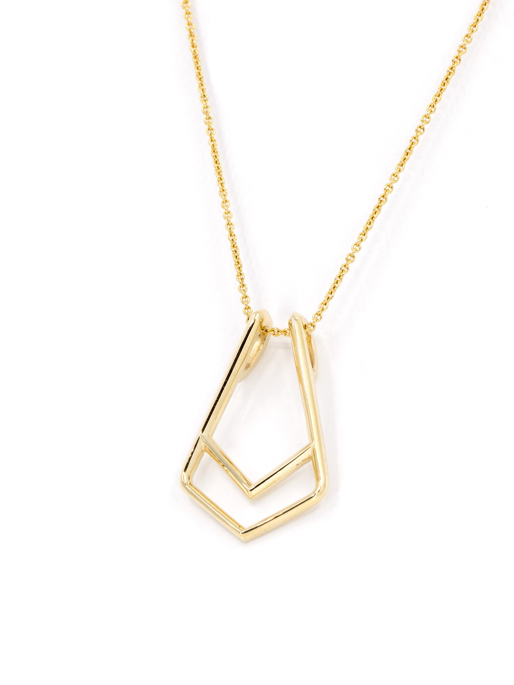 A modern jewelry solution: gold ring holder pendant in natural light – High-polish gold reflecting soft light, showcasing the elegant yet bold aesthetic of this designer piece.