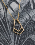 Close-up of Ring Holder Pendant in Yellow Gold – A contemporary fine jewelry piece with a minimalist and functional design.