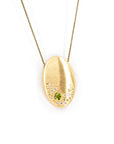 Custom Oval 22K Gold Pendant with Peridot & Diamonds, made in Montreal – A bespoke gold necklace featuring scattered bezel-set diamonds and a round peridot, designed by Bena Jewelry.