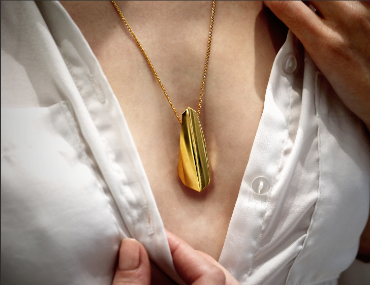 Woman wearing statement gold plated pendant Bena Jewelry Edgy Collection