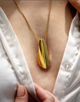 Woman wearing statement gold plated pendant Bena Jewelry Edgy Collection