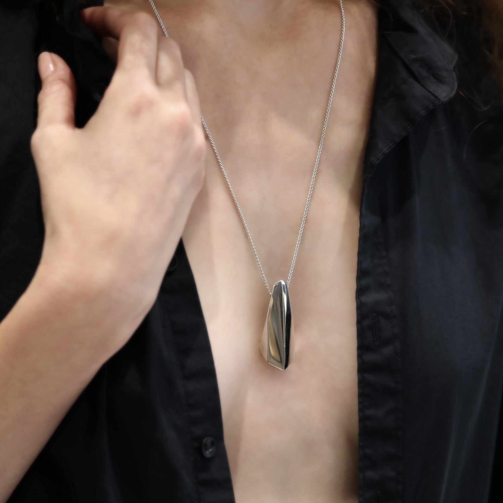 Womant wearing statement sterling silver pendant