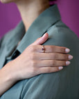 Elegant bridal ring featuring a pyrope garnet and diamonds in yellow gold Désir Pyrope Garnet Ring by Bena Jewelry worn by a woman on her shoulder custom bridal jewelry from Montreal.