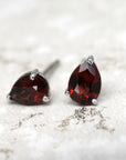 front view of bena jewelry pyrope garnet earrings pear shape red garnet gemstone stud earrings handmade in montreal natural red gemstone earrings silver bena jewelry custom made jewelry color gems earrings montreal
