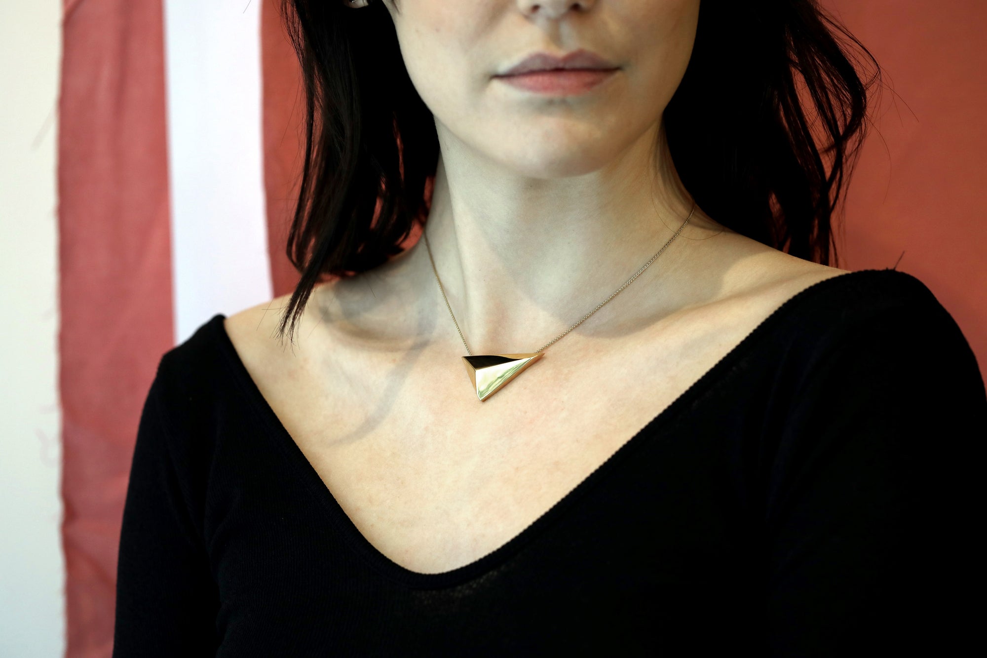 Women with a black shirt wearing vermeil gold pyramidal pendant Edgy Collection Montreal Made in Canada