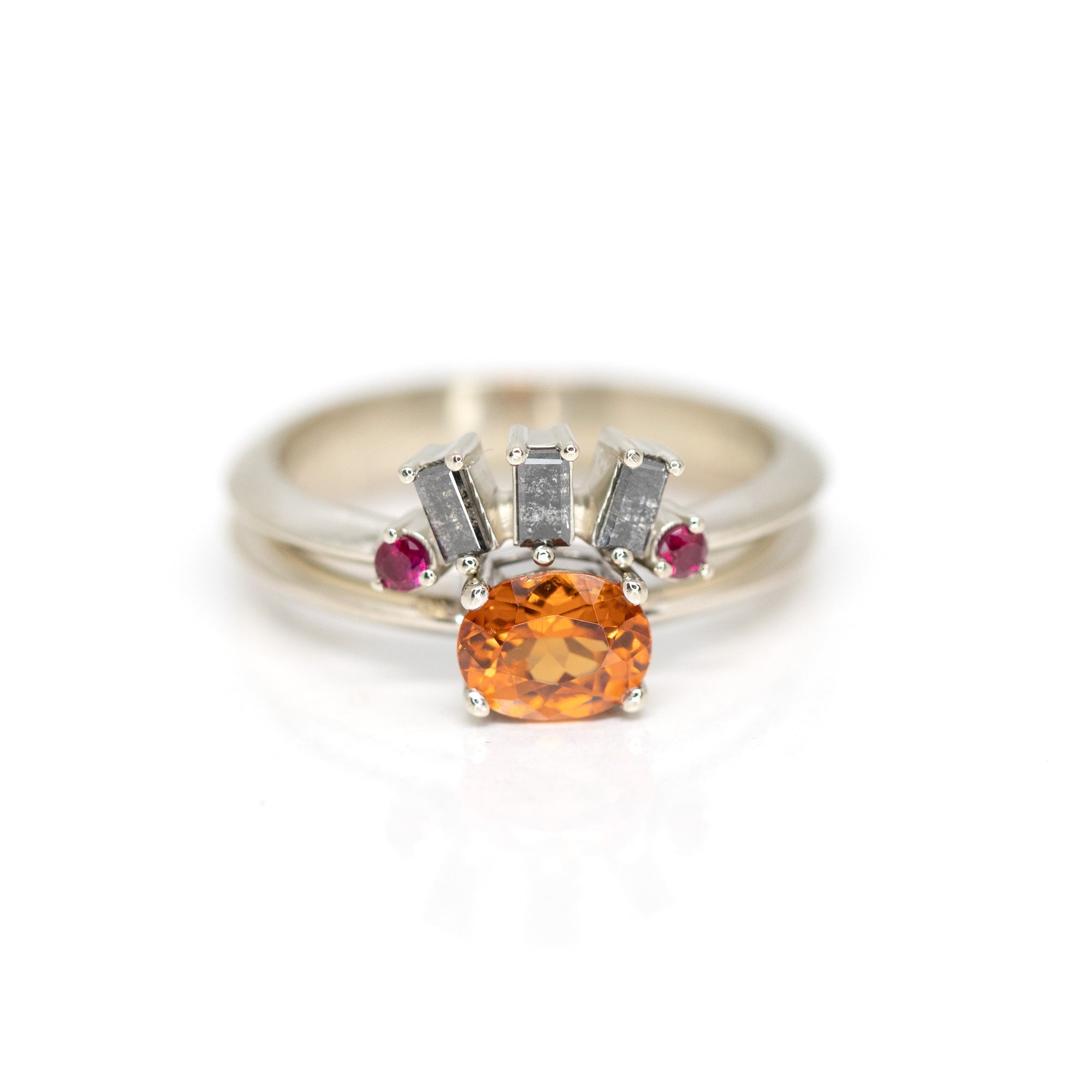 front view of salt and pepper diamond baguette wedding abnd and matching spessartite garnet engagement ring made in montreal by bena jewelry designer on a white background