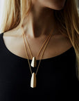 Woman wearing statement gold plated pendant Edgy Collection bena jewelry custom jewelry designer montreal made in canada