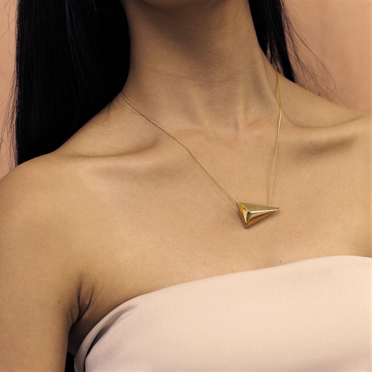 Woman wearing statement gold plated pendant Bena Jewelry Edgy Collection