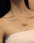 Woman wearing statement gold plated pendant Bena Jewelry Edgy Collection