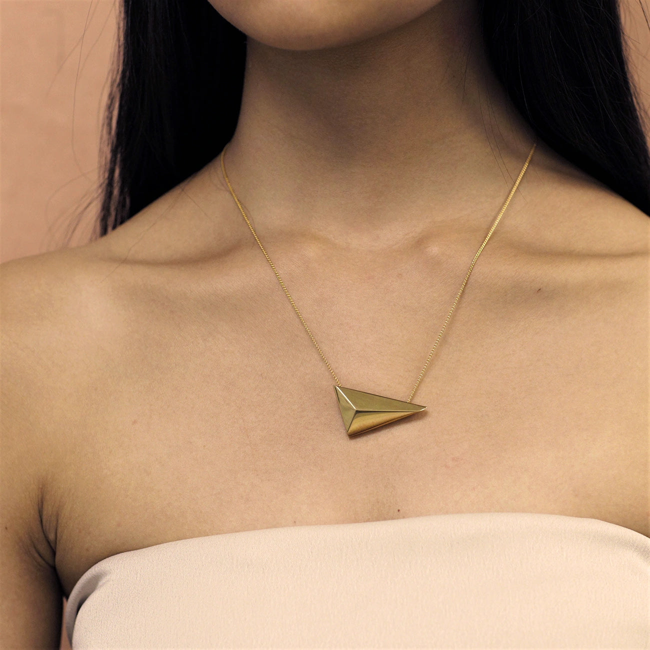 Woman wearing statement gold plated pendant Bena Jewelry Edgy Collection