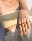 A close-up view of the GRAND PUNCH ring by Montreal jewelry designer Bena Jewelry, here worn by a casual young woman. This double finger ring in solid gold empowers. It’s a jewel of strength, style, courage and ambition.