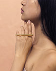 An asiatic lady wears a modern statement ring designed in Montreal by Bena Jewelry. This unisex bold jewelry piece is designed to empower and exudes energy, confidence and strength. For people with ambition and style.