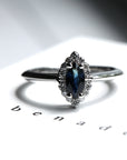 Front view of marquise shape blue sapphire montreal made in canada bena jewelry edgy fine jewelry with white gold ring with small white diamond signature design montreal made in canada