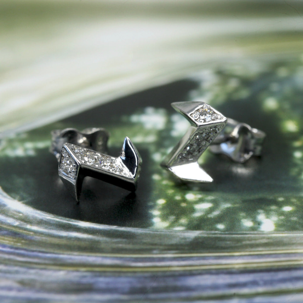 Natural light silver stud earrings thunder shape with round diamond Bena Jewelry Montreal On Green Background