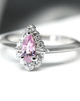 Front view of custom made ring pear shape sapphire bena jewelry edgy engagement ring color gemstone bridal ring montreal diamond jewelry handmade in canada white gold diamond and color gems rings