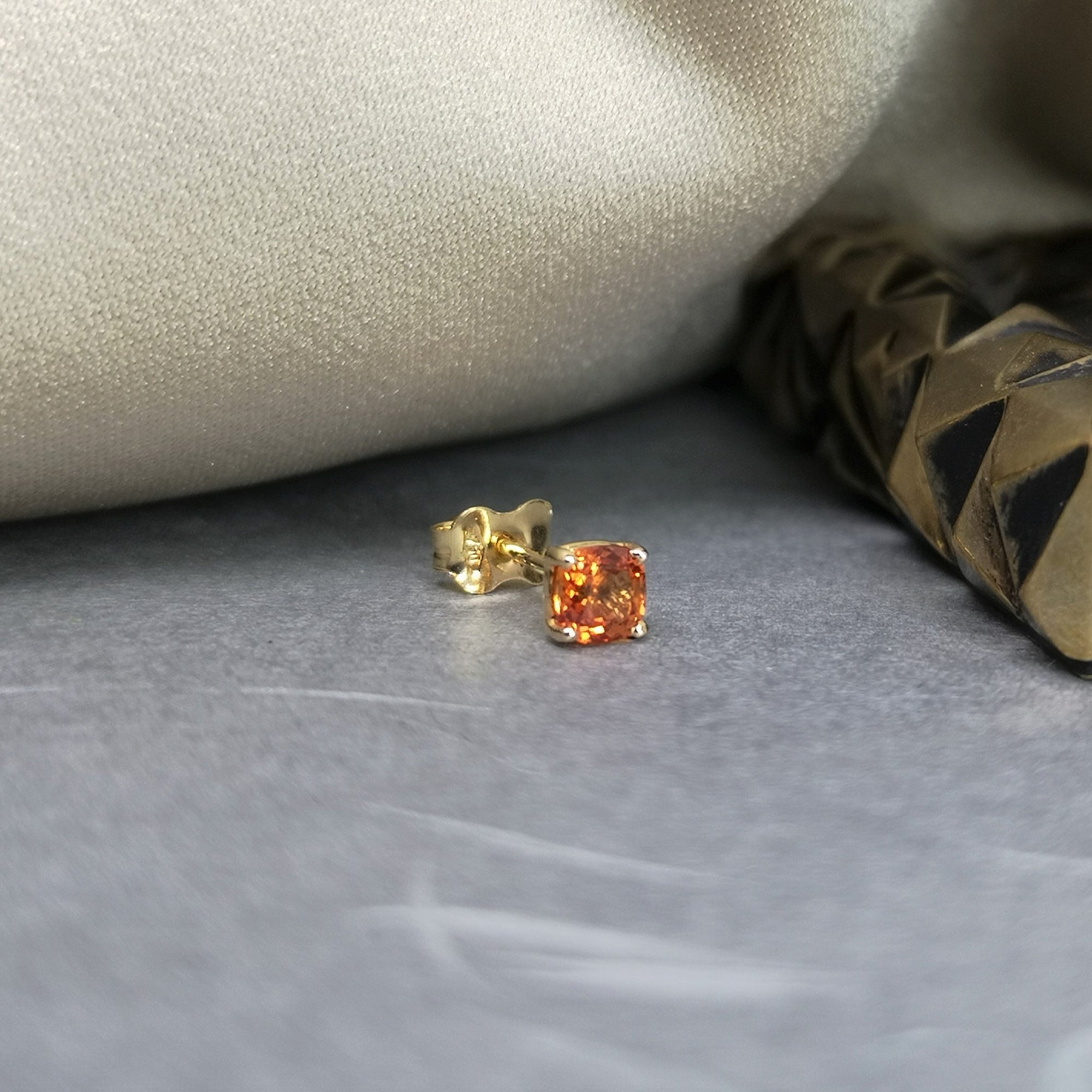 Orange sapphire gemstone trillion cut stud earrings 18 kt yellow gold