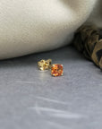 Orange sapphire gemstone trillion cut stud earrings 18 kt yellow gold