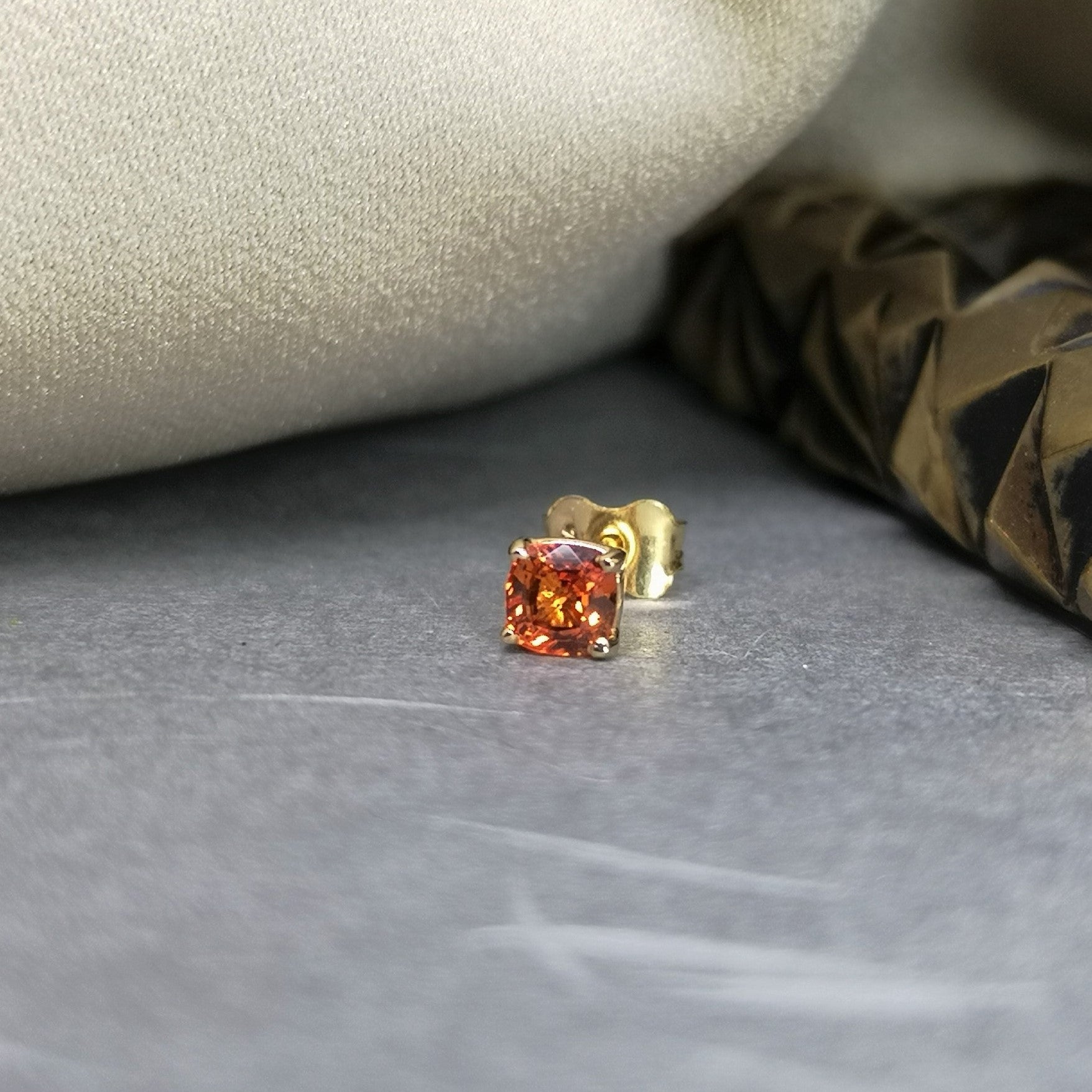 Orange sapphire gemstone trillion cut stud earrings 18 kt yellow gold
