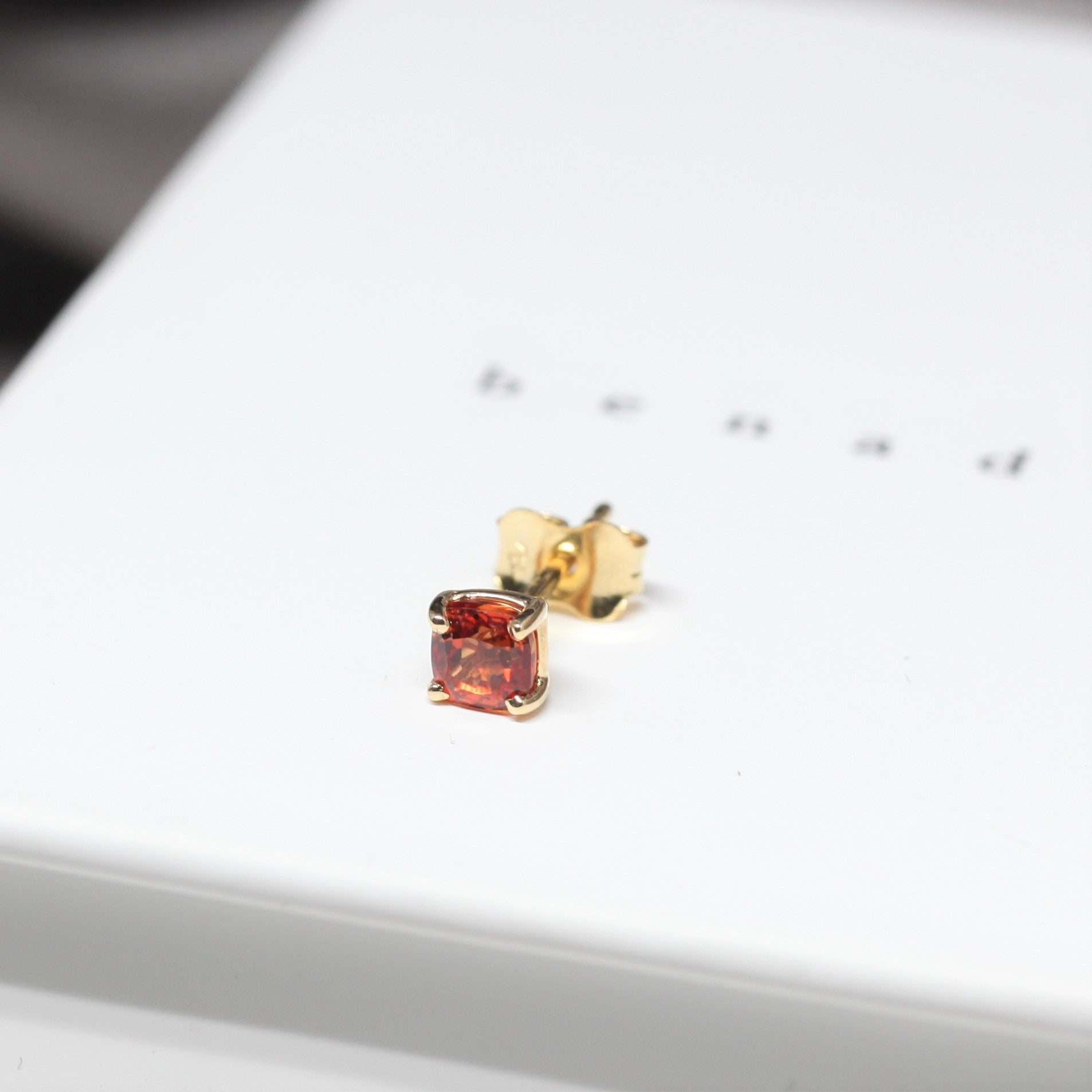 Orange sapphire gemstone trillion cut stud earrings 18 kt yellow gold