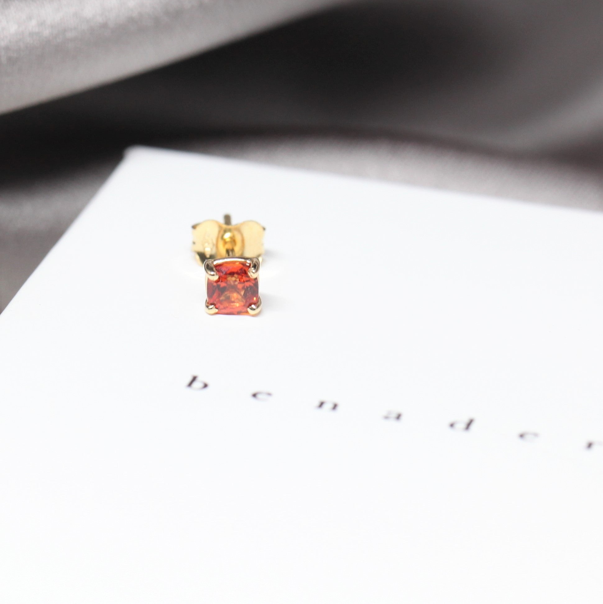 Orange sapphire gemstone trillion cut stud earrings 18 kt yellow gold