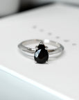 Top view of bena jewelry black gemstone engagement ring montreal dark spinel pear shape black gems gold ring custom made color gemstone bridal jewelry and engagement ring designer and handmade in montreal little italy fine jeweler one of the kind black gemstone engagement ring