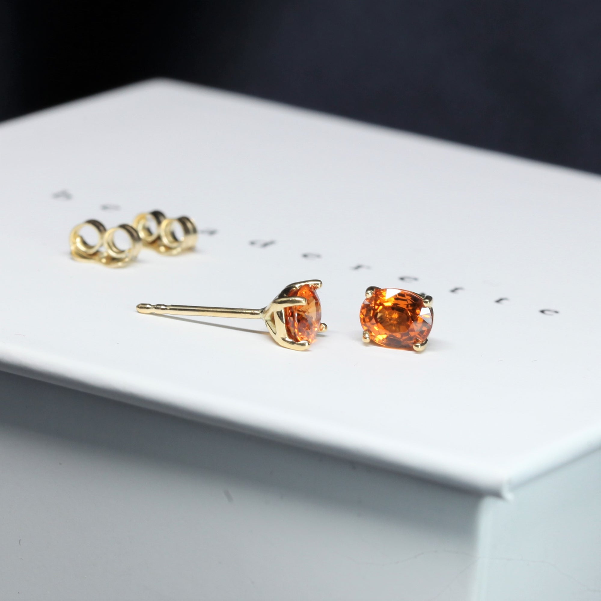 side view of bena jewelry garnet stud earrings made in montreal vivid natural orange gemstone stud earrings bena bridal jewelry montreal made custom made unisex fine jewlery with natural color gemstone montreal made in canada bena jewlelry designer