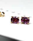 front view of rhodolite garnet purple gemstone gold stud earrings minimalist gemstone jewelry handamde in montreal made in little italy fine jewelry studio natural pink purple garnet gemstone jewelry montreal