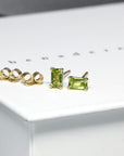 front view of peridot baguette jewelry gemstone stud earrings bena jewelry montreal specialist vivid green gemstone earrings custom made fine jewelry montreal green gemstone jewels earrings bena earrings