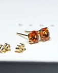 side view of garnet earrings oval shape spessartite orange gemstone stud earrings natural orange color yellow gold stud earrings oval shape vivid orange gemstone stud earrings custom made color gemstone bridal jewelry montreal bena jewelry designer