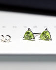 side view of bena jewelry gemstone stud earrings trillion shape peridot custom made gemstone jewelry bridal earrings bena jewelry montreal gemstone jewelry manufacture montreal color gemstone jewelry specialist small green gems earrings
