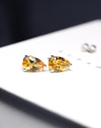 Side view of citrine gemstone stud earrings bena jewelry minimalist color gems earrings little italy montreal jeweler custom made fine jewelry color gemstone pear shape natural yellow quartz earrings