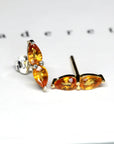 Front view of pear shape sapphire color gemstone stud earrings edgy jewelry montreal custom made in fine jewelry fancy color gemstone orange sapphire natural gemstone jewelry specialist montreal handmade in canada