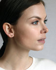 top view of a girl wearing bena jewelry gemstone studs earrings montreal color gemstone jewelry specialist handmade jewelry small gems jewelry green gemstone small gold earrings bena jewelry edgy gemstone jewelry