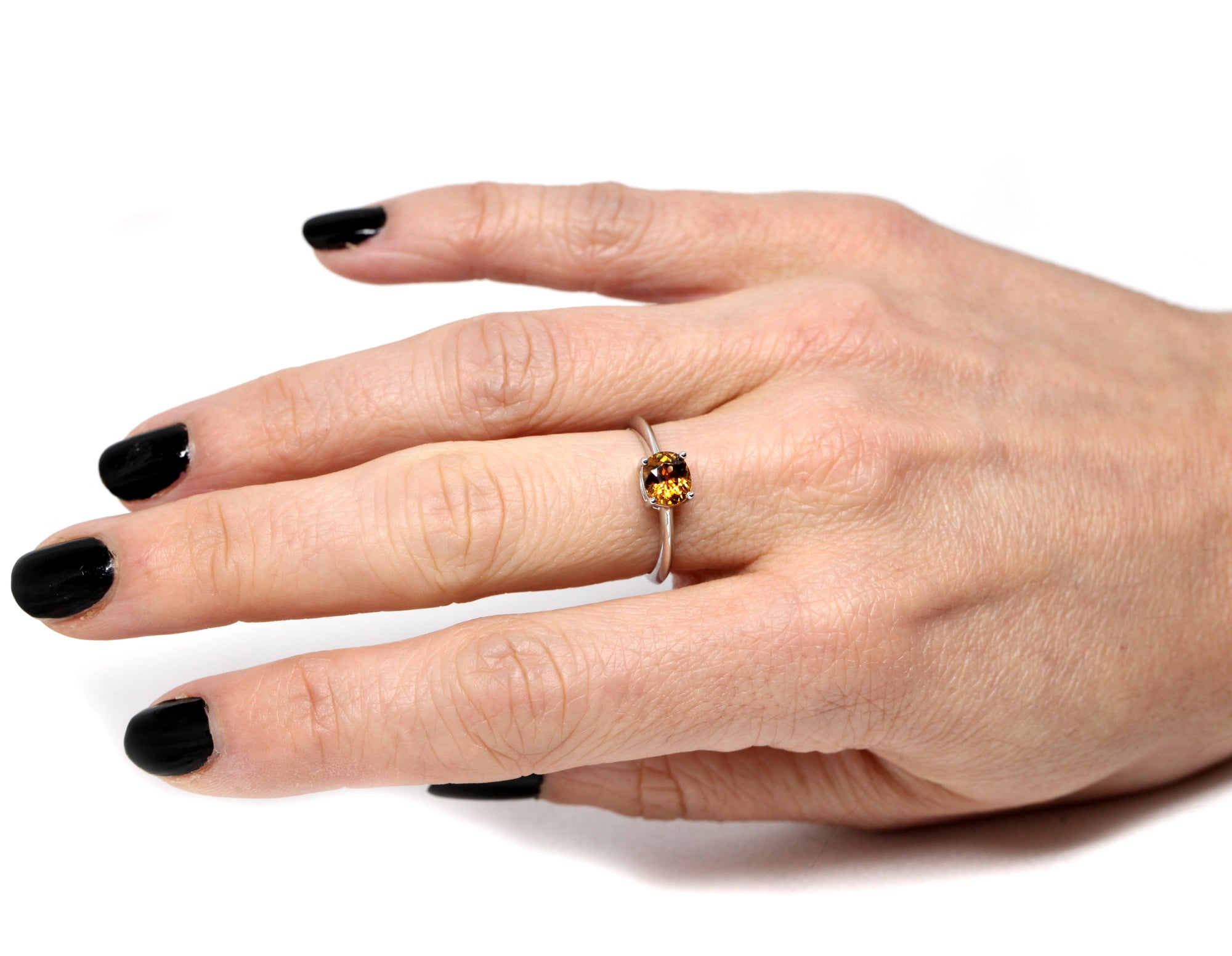 girl wearing color gemstone engagement ring natural zircon fire orange gemstone gold ring handmade in montreal little italy minimalist gold engagement ring with fancy color gemstone oval shape natural gems bena jewelry montreal custom made jewelry white gold ring orange natural gemstone