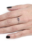 girl wearing pink pear shape garnet engagement ring montreal handmade fine jewelry small pear shape pink gemstone fine jewelry montreal handamde fine jewelry custom made colored gemstone jewelry montreal