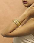 Girl wearing statement gold plated bracelet chiseled collection by bena jewelry montreal custom fine jewelry designer montreal made in canada