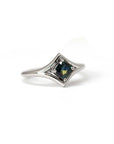 Elegant and edgy, this custom-made white gold ring showcases a vivid teal sapphire, designed for those seeking unique, modern jewelry. Handmade in Montreal.