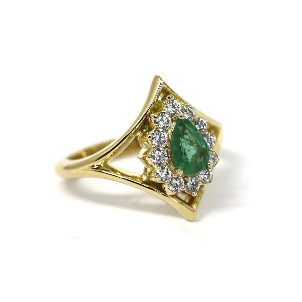 Front view of the Adorn Pear Shape Emerald & Halo Ring by Bena Jewelry, showcasing the pear-shaped emerald and its yellow gold halo. Made in Montreal, Canada, this custom piece highlights fine craftsmanship.
