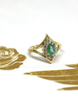 The Adorn Pear Shape Emerald & Halo Ring, showcasing its vibrant emerald and refined yellow gold design. Made in Montreal, Canada, by Bena Jewelry, a bespoke piece.