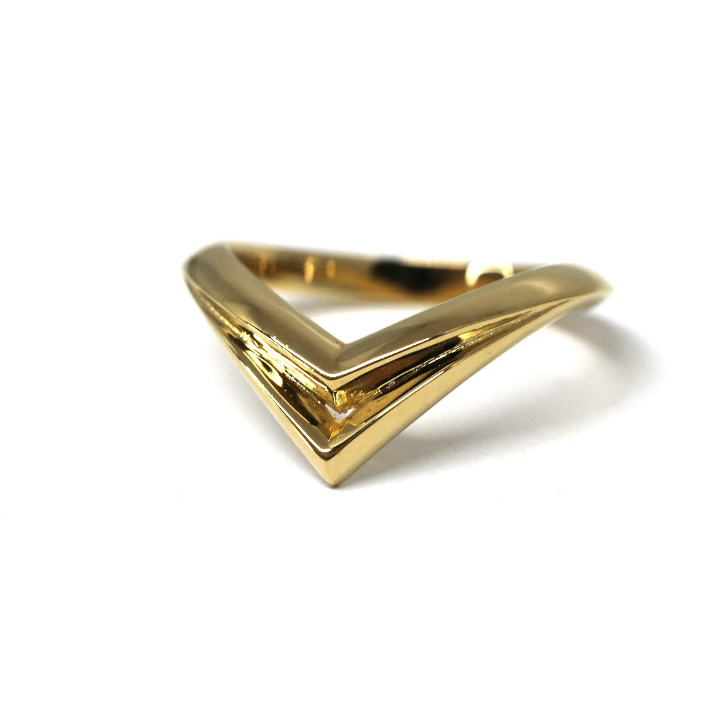 Sleek yellow gold ring with angular curves, Adorn Ring by Bena Jewelry, displayed on a clean white background, modern edgy jewelry from Canada.