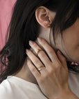 Adorn Yellow Gold Ring by Bena Jewelry, featuring a bold V-shaped design, worn on a woman’s hand, showcasing its modern and edgy style.