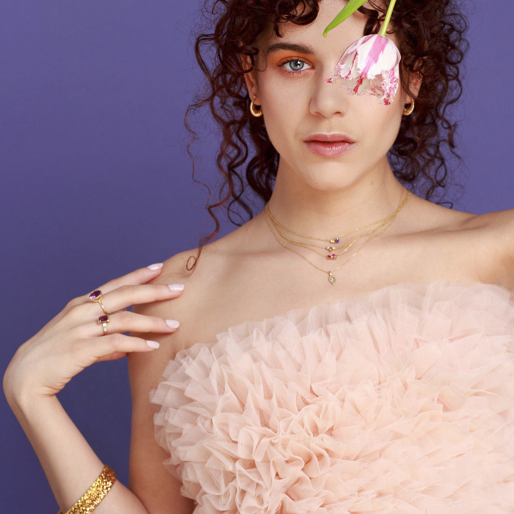 Statement cocktail ring in yellow gold with a Brazilian round amethyst, worn to showcase its unique design by Bena Jewelry, designer canadien.