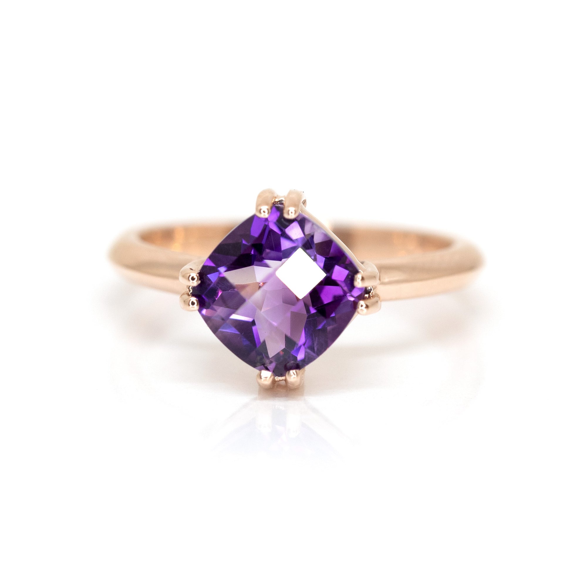 Cushion-cut amethyst ring set in warm rose gold, featuring a deep purple Brazilian gemstone. Custom-made in Montreal by Bena Jewelry.
