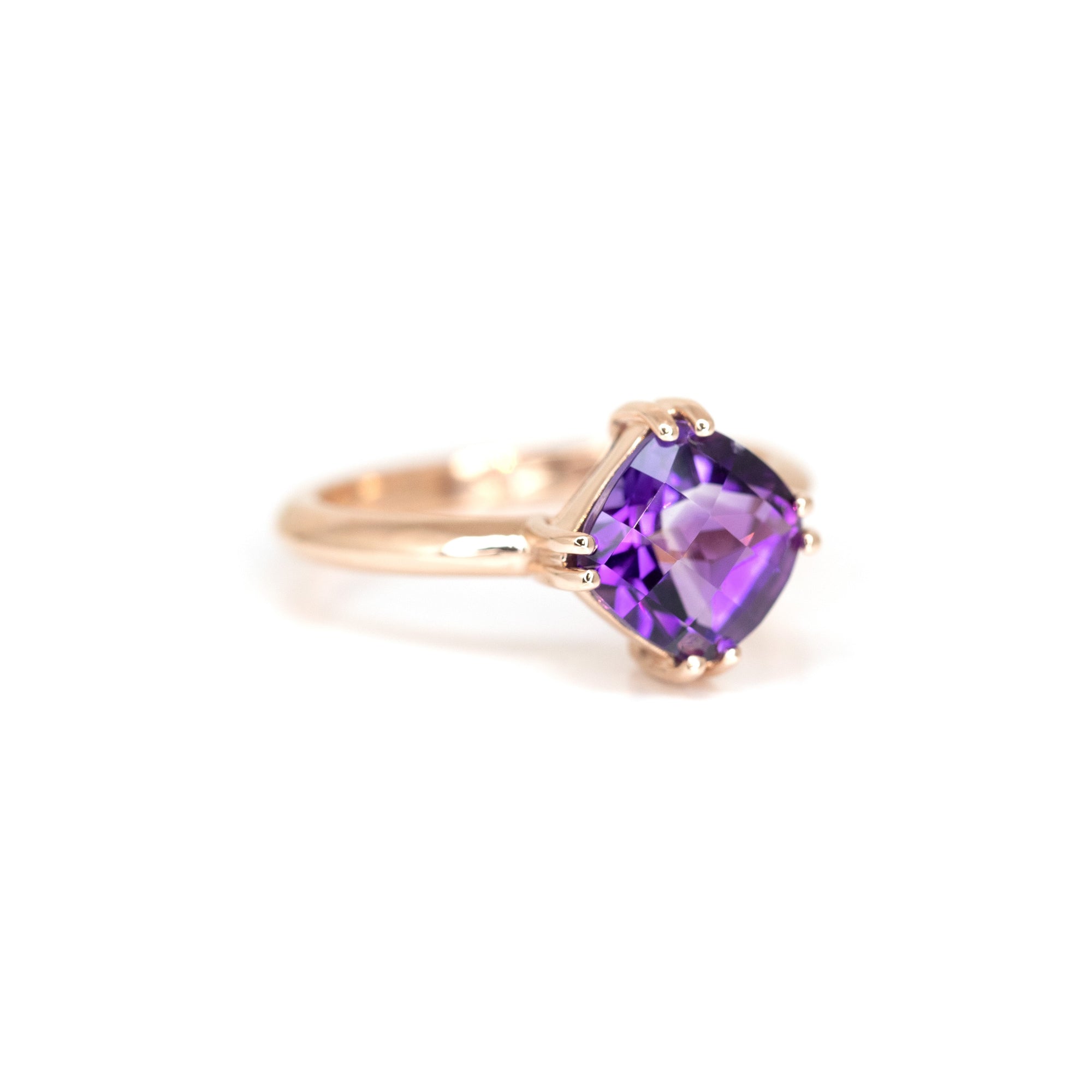 Sleek and modern, this cushion-cut amethyst ring in rose gold highlights the gemstone’s brilliance and depth. Handmade by Bena Jewelry.